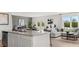 Open-concept kitchen featuring a large island, stainless steel appliances, and adjacent living room at 3038 Manor Hill Pl, Union City, GA 30291