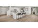 Open kitchen boasts a large island with seating, white cabinets, and stainless steel appliances at 3038 Manor Hill Pl, Union City, GA 30291