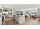 Open-concept kitchen featuring a large island, stainless steel appliances, and adjacent living area at 3038 Manor Hill Pl, Union City, GA 30291