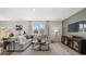A sun-filled living room with a plush sofa, contemporary decor, and sliding glass doors to an outdoor space at 3038 Manor Hill Pl, Union City, GA 30291