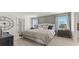 The main bedroom features plush carpeting, contemporary lamps, and a neutral color palette for a relaxing retreat at 3038 Manor Hill Pl, Union City, GA 30291