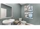 A modern powder room featuring stylish artwork, sleek fixtures, and a pedestal sink with ample counter space at 3038 Manor Hill Pl, Union City, GA 30291