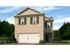 Charming two-story home featuring a brick facade, attached garage, and lush green landscaping at 3040 Manor Hill Pl, Union City, GA 30291