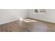 Bright bedroom featuring stylish wood-look flooring and natural light from a window at 3042 Manor Hill Pl, Union City, GA 30291