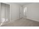 This bedroom features neutral carpet, an open closet, and an open entry at 3042 Manor Hill Pl, Union City, GA 30291