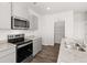 Bright kitchen features stainless steel appliances, granite countertops, and ample cabinet space at 3042 Manor Hill Pl, Union City, GA 30291