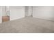 Spacious carpeted bedroom with an ensuite bathroom and closet entrances at 3044 Manor Hill Pl, Union City, GA 30291