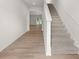 Bright entryway with hardwood flooring leading to a carpeted staircase and open living area at 3044 Manor Hill Pl, Union City, GA 30291