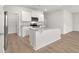 Modern kitchen with a large center island, stainless steel appliances, and sleek white cabinets at 3044 Manor Hill Pl, Union City, GA 30291