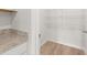 Convenient pantry with granite countertops, storage shelves, and wood-look flooring at 3044 Manor Hill Pl, Union City, GA 30291