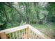 Overlooking the serene and lush backyard from the wooden deck at 329 Kelly Mill Rd, Cumming, GA 30040