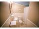 Cozy bathroom featuring a single sink, toilet, and shower with neutral colors and wainscoting at 329 Kelly Mill Rd, Cumming, GA 30040