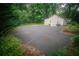Spacious driveway offering ample parking, surrounded by greenery and leading to the charming home at 329 Kelly Mill Rd, Cumming, GA 30040