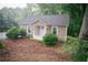 Charming cottage-style home featuring a cozy front porch and a well-maintained, tree-lined landscape at 329 Kelly Mill Rd, Cumming, GA 30040