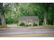 Cozy home nestled among mature trees; features a quaint facade, and is conveniently located near a road at 329 Kelly Mill Rd, Cumming, GA 30040