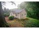Charming cottage-style home surrounded by lush greenery; featuring a cozy front porch and a tranquil setting at 329 Kelly Mill Rd, Cumming, GA 30040