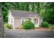 Quaint cottage-style home featuring a cozy front porch and is surrounded by lush greenery and mature trees at 329 Kelly Mill Rd, Cumming, GA 30040