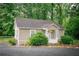 Cozy cottage-style home featuring a charming front porch and is surrounded by lush greenery and mature trees at 329 Kelly Mill Rd, Cumming, GA 30040