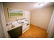 Small kitchenette with a sink, electric stove, and hardwood floor at 329 Kelly Mill Rd, Cumming, GA 30040