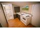 Small kitchenette with a sink, electric stove, and hardwood floor at 329 Kelly Mill Rd, Cumming, GA 30040
