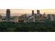 Scenic aerial view of a vibrant city skyline behind lush green trees at 4132 Carmain Ne Dr, Atlanta, GA 30342