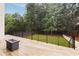 Beautiful backyard featuring a stone fire pit, lush green grass, and privacy fence at 4132 Carmain Ne Dr, Atlanta, GA 30342