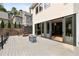 Backyard featuring a wooden deck, gray fire pit, black metal railings, multiple sliding glass doors, and well-maintained green lawn at 4132 Carmain Ne Dr, Atlanta, GA 30342