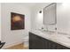 A sleek half bathroom with a marble countertop sink, modern fixture and elegant decor at 4132 Carmain Ne Dr, Atlanta, GA 30342