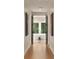 Hallway view of the bathroom featuring a standalone tub, minimalist decor, and natural light at 4132 Carmain Ne Dr, Atlanta, GA 30342