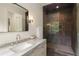 A modern bathroom featuring a glass shower and marble countertop at 4132 Carmain Ne Dr, Atlanta, GA 30342