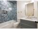 Charming bathroom with blue tile accents, a marble vanity, and vintage-inspired fixtures create a stylish design at 4132 Carmain Ne Dr, Atlanta, GA 30342