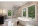 Luxurious bathroom featuring a standalone tub, walk-in shower, double vanity, and marble accents at 4132 Carmain Ne Dr, Atlanta, GA 30342
