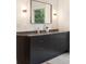 Bathroom vanity with gray marble countertop and custom dark cabinetry with stylish modern sink fixtures and lighting at 4132 Carmain Ne Dr, Atlanta, GA 30342