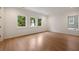 Bright and airy bedroom featuring hardwood floors, large windows, and neutral colors to create a calm atmosphere at 4132 Carmain Ne Dr, Atlanta, GA 30342