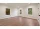 Spacious bedroom with hardwood floors, recessed lighting, and large windows providing ample natural light and scenic views at 4132 Carmain Ne Dr, Atlanta, GA 30342
