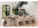 Dining room features modern table with seating for eight, staircase, and large windows offering lush views at 4132 Carmain Ne Dr, Atlanta, GA 30342