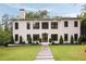 Imposing two-story home with manicured lawn, stone walkway, and modern architectural style at 4132 Carmain Ne Dr, Atlanta, GA 30342