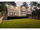 Rear exterior view of home showcases modern design, inviting deck, and landscaped backyard at 4132 Carmain Ne Dr, Atlanta, GA 30342