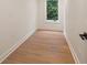 Hallway featuring beautiful hardwood flooring, white trim, natural light from the window and neutral decor at 4132 Carmain Ne Dr, Atlanta, GA 30342