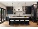 Modern kitchen with a large island, sleek black cabinetry, and stainless steel appliances at 4132 Carmain Ne Dr, Atlanta, GA 30342