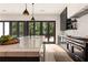 The kitchen features sleek, black cabinets, stainless steel appliances, and a large island at 4132 Carmain Ne Dr, Atlanta, GA 30342