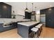 The kitchen features black cabinets, an island with seating, and stainless steel appliances at 4132 Carmain Ne Dr, Atlanta, GA 30342