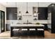 Modern kitchen with sleek dark cabinetry, large island with bar seating, and stainless steel appliances at 4132 Carmain Ne Dr, Atlanta, GA 30342