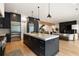 A modern kitchen featuring black cabinets, a marble island, and stainless steel appliances at 4132 Carmain Ne Dr, Atlanta, GA 30342
