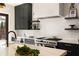 Bright kitchen with white backsplash, modern countertops, and stainless steel gas range at 4132 Carmain Ne Dr, Atlanta, GA 30342