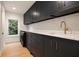 Well-equipped laundry room featuring custom cabinetry, quartz countertops, modern fixtures, and a washing machine at 4132 Carmain Ne Dr, Atlanta, GA 30342