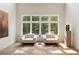 Sunlit sitting area with plush chairs and a large window showcasing the greenery outside at 4132 Carmain Ne Dr, Atlanta, GA 30342