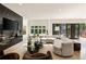 Inviting living room showcasing fireplace, hardwood floors, and access to a private patio with outdoor space at 4132 Carmain Ne Dr, Atlanta, GA 30342
