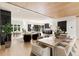 Open-concept living space with hardwood floors, marble accent wall, seamlessly connecting to modern kitchen at 4132 Carmain Ne Dr, Atlanta, GA 30342