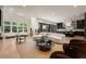 Open concept living room with modern furnishings, kitchen, and abundant natural light at 4132 Carmain Ne Dr, Atlanta, GA 30342